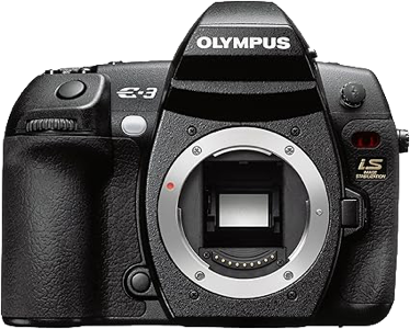 A black Olympus camera body with no lens attached, showing the sensor and various control buttons.